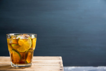 Cuba libre cocktail with cola and lime. Selective focus.