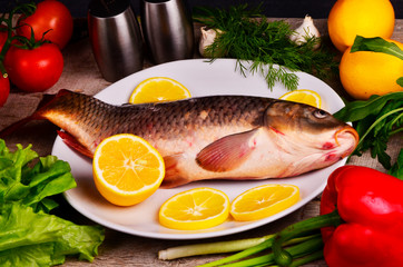 fresh fish Cyprinus carpio carpio with the vegetables  and lemon