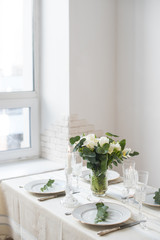 Beautiful festive table setting with elegant white flowers and cutlery, dinner table decoration 