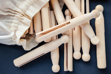 Wooden vintage retro clothes pegs in a white cloth bag