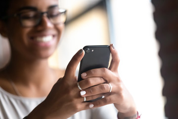 Close up hands of young black woman holding smartphone