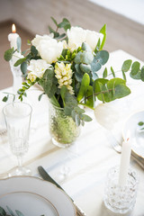 Beautiful festive table setting with elegant white flowers and cutlery, dinner table decoration 