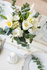 Beautiful festive table setting with elegant white flowers and cutlery, dinner table decoration 