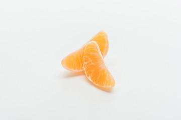 ripe bright orange tangerine slices on white background