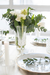 Beautiful festive table setting with elegant white flowers and cutlery, dinner table decoration 