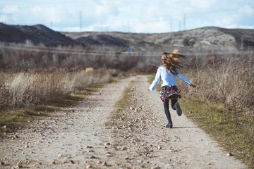 Little girl running around the very happy field