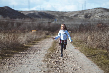 Little girl running around the very happy field