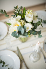 Beautiful festive table setting with elegant white flowers and cutlery, dinner table decoration 