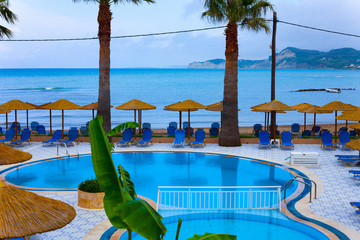 Sunny day on the beach with umbrellas and seats. Blue sky at the beautiful weather. Holiday concept...