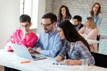 Creative young business people and architects working in office