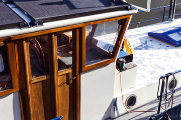 Wooden cabine on the boat on the sunny day. Nature and fishing concept with boat on the river