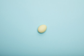 Fototapeta na wymiar Top view of easter egg on blue background