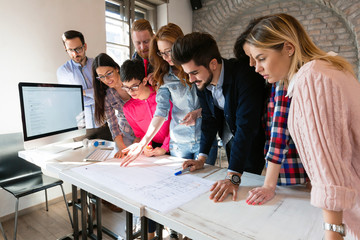 Creative young business people and architects working in office