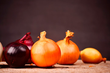 colorful onions on rustic wooden background