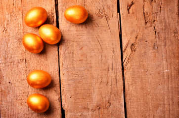  golden eggs on wooden background. investment concept