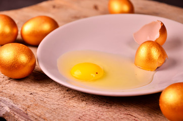 to smash the Golden egg on wooden background
