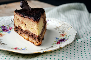 a delicious sweet piece of cake and a bottle of milk on the tablecloth polka dot