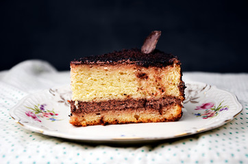 a delicious sweet piece of cake and a bottle of milk on the tablecloth polka dot