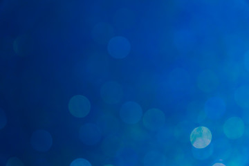 Blue bokeh background, abstract defocused lights.