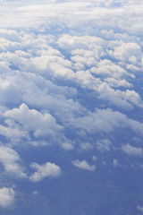 Natural panorama of blue sky with light clouds from plane. Concept of air transport, travel, tourism, business. Environmental problem of gas pollution.