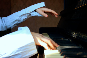 Young Girl Playing The Piano Diligently.Cropped Shot Of A Little Girl Playing The Piano.Cropped...