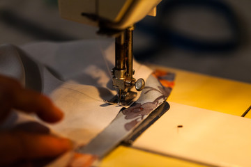 Women's hands on the sewing machine. Industry concept with creating clothes