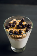 Healthy and tasty breakfast with muesli black currant and yogurt. Selective focus.