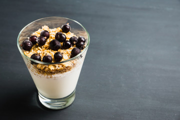 Healthy and tasty breakfast with muesli black currant and yogurt. Selective focus.