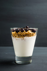 Healthy and tasty breakfast with muesli black currant and yogurt. Selective focus.