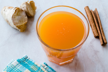 Jamu Healthy Asian Drink with Turmeric and Cinnamon Stick, Orange Juice
