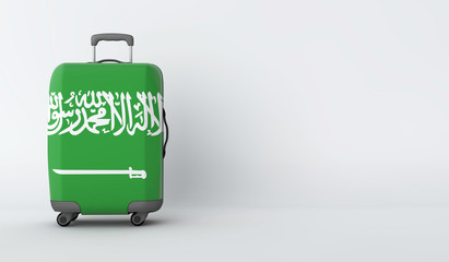 Travel suitcase with the flag of Saudi Arabia. Holiday destination. 3D Render