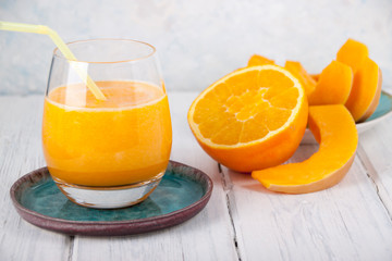 Pumpkin juice with orange juice in a glass goblet