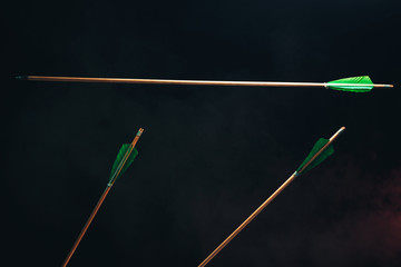 Three wood arrow one flying . Beautiful  smog background. Medieval weapons are handmade.