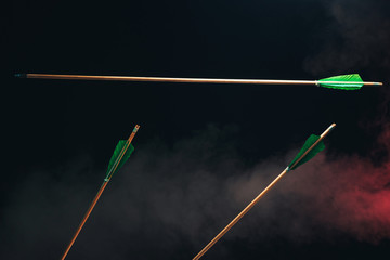 Three wood arrow one flying . Beautiful  smog background. Medieval weapons are handmade.