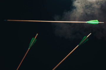 Three wood arrow one flying . Beautiful  smog background. Medieval weapons are handmade.