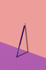 purple pencil on purple floor and pink wall