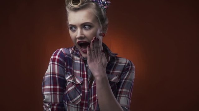 Amazing blonde pin up girl with surprised expression on her face, close up, slow motion