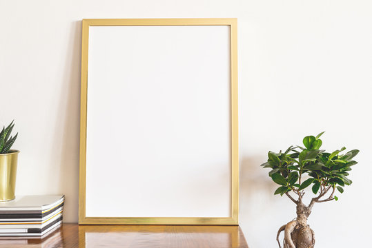 Gold Poster Frame In Bright Interior.