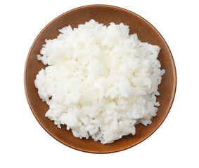 White rice in brown bowl isolated on white background. top view