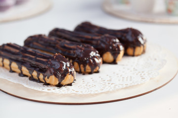 chocolate filled eclairs on white background