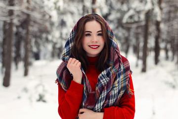 Winter portrait of a beautiful smiling girl. Walk in the Park on a cold winter day