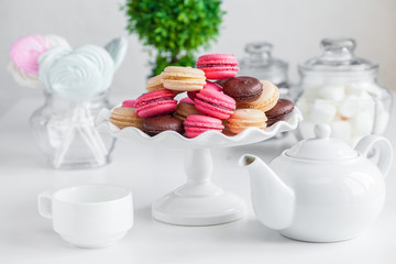 pink and chocolate macaroons on a white plate