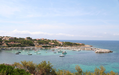 Fototapeta na wymiar Small boats at anchor in the bay at Algajola on the northern coast of Corsica, France