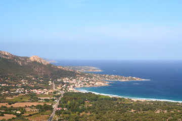 Fototapeta na wymiar The northern coast of Corsica, France, around the village of Algajola.Beautiful view of the blue Mediterranean meeting the pristine shore.