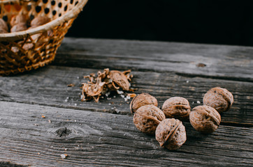 lots of nuts and a basket of nuts on the wooden table