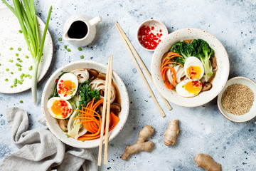 Ramen traditional japanese noodle soup with eggs, pak choi cabbage, meat broth, carrot, mushrooms...
