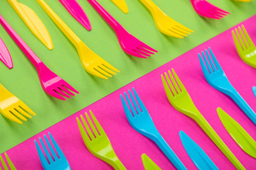 Many color plastic cutlers on a bright background