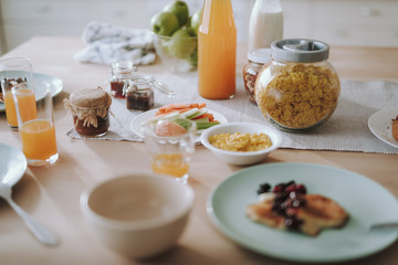Healthy breakfast on the table with juice in bottle and glasses