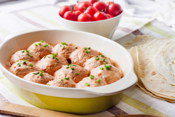 Chicken meatballs baked in creamy tomato sauce