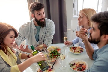 Friends having lunch together at home